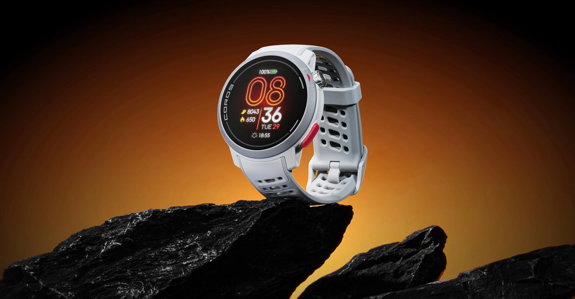 Smartwatch on a rock with an orange gradient background. Coros Pace Pro