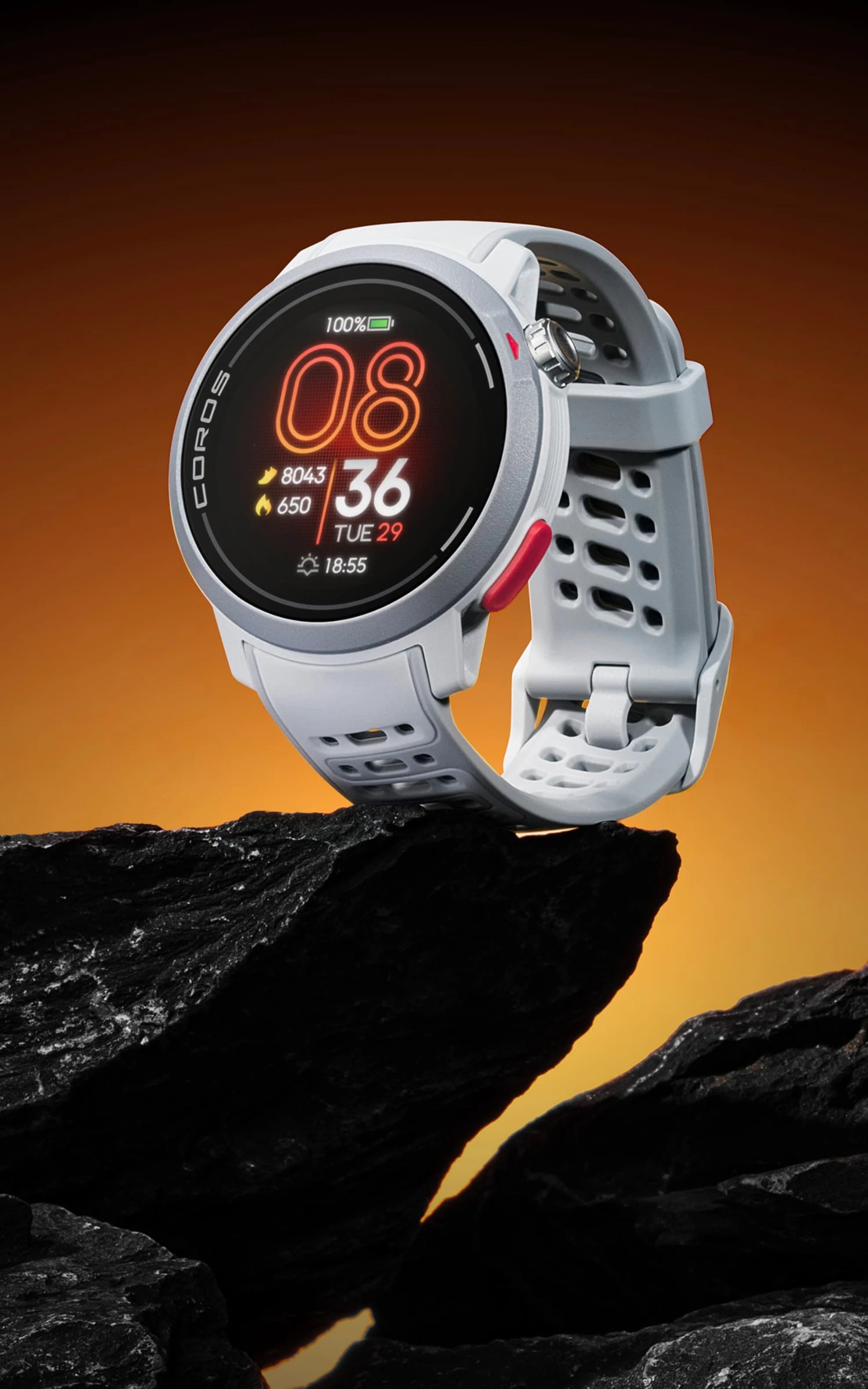 White smartwatch on a rock with an orange background. Coros Pace Pro